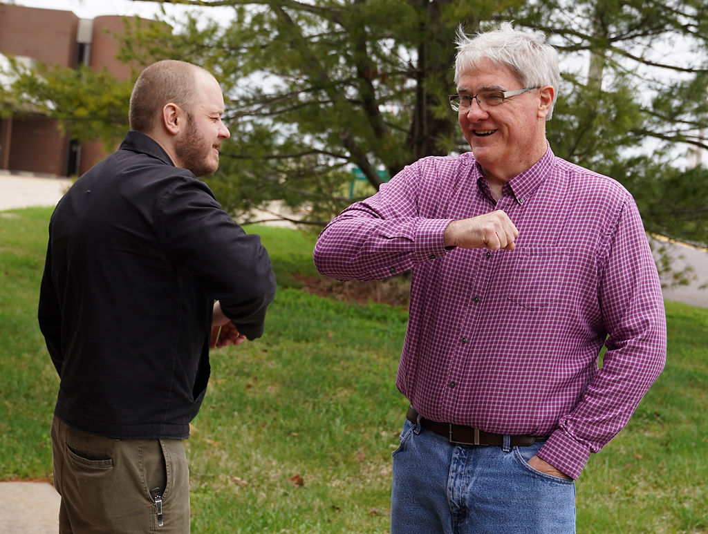 From left, Lee Sensinataffar and Mark Palmer give each other an elbow bump